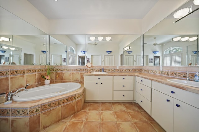 bathroom with vanity, a relaxing tiled tub, tile patterned floors, and ceiling fan