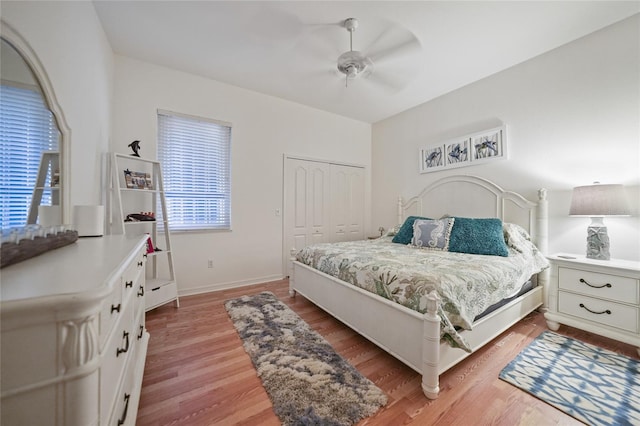 bedroom with wood-type flooring, a closet, and ceiling fan