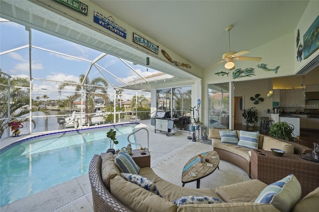 view of swimming pool featuring a water view, an outdoor hangout area, a patio, and a lanai