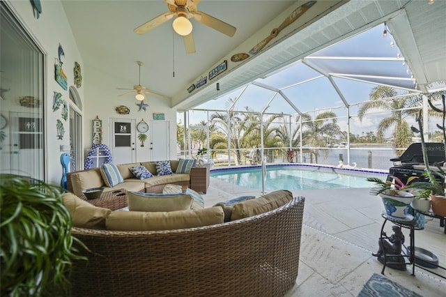 view of pool featuring a patio, outdoor lounge area, and glass enclosure