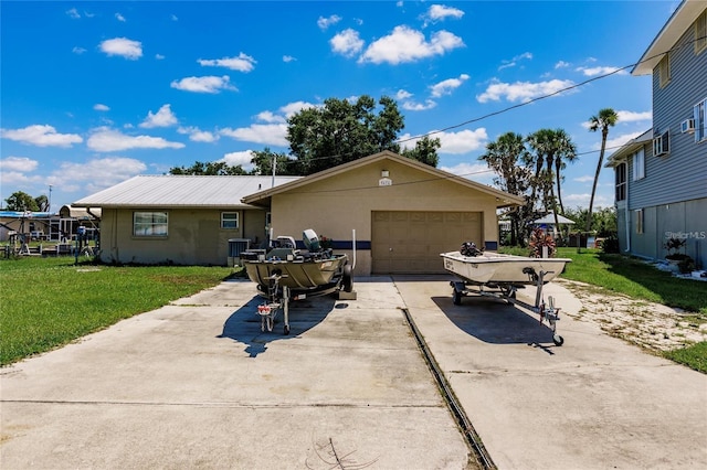 single story home with a garage and a front lawn