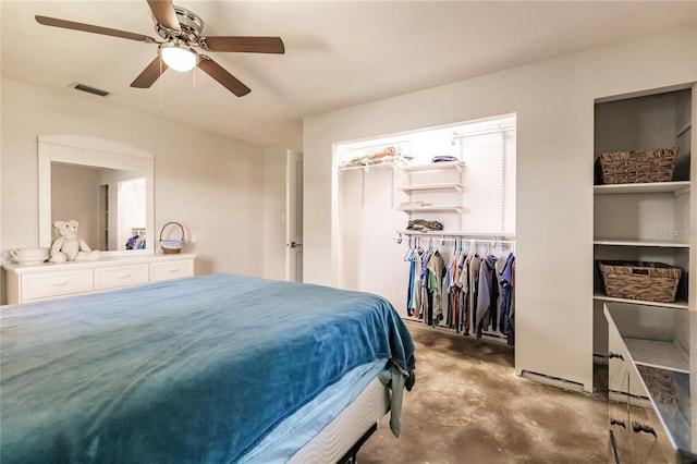 bedroom featuring concrete flooring, ceiling fan, and a closet