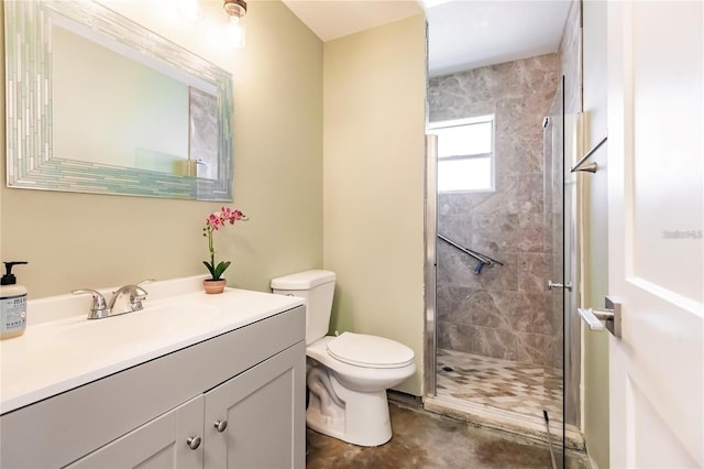 bathroom featuring vanity, a shower with shower door, and toilet