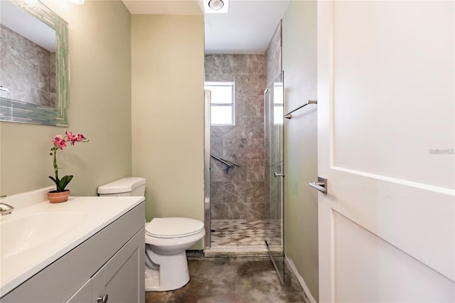 bathroom featuring vanity, toilet, and a shower with shower door