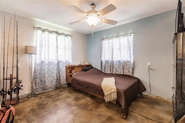 bedroom featuring multiple windows and ceiling fan