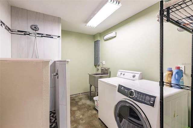 laundry room featuring a barn door, separate washer and dryer, sink, and electric panel