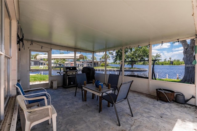 sunroom / solarium featuring a water view