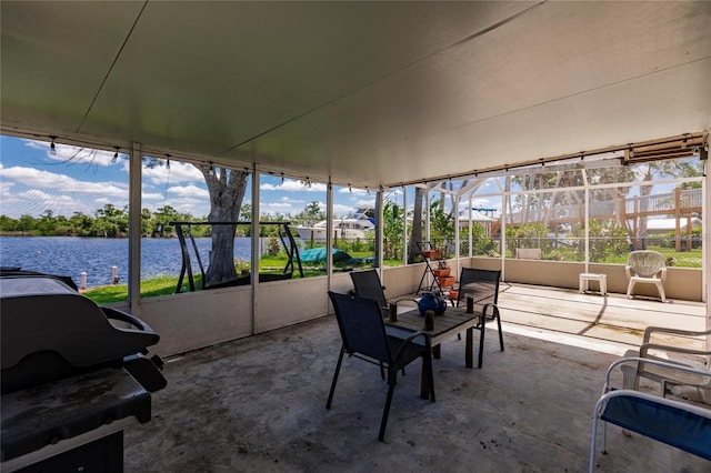 unfurnished sunroom with a water view