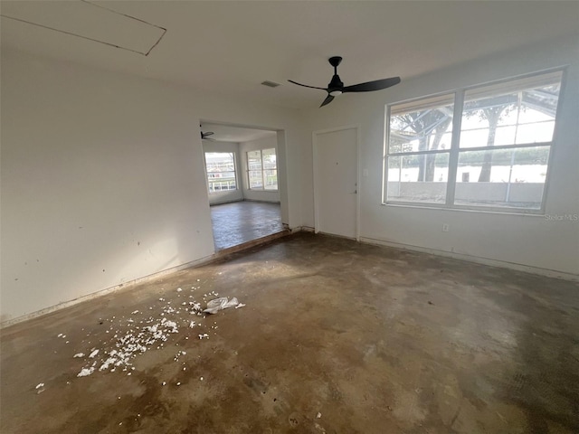 9656 SW Marina Dr, Arcadia, FL 34269 - spare room featuring attic access, ceiling fan, and concrete floors