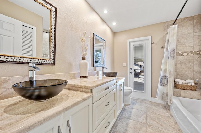 full bathroom featuring vanity, toilet, and shower / tub combo with curtain