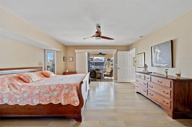 bedroom with access to exterior, ceiling fan, a textured ceiling, and light wood-type flooring