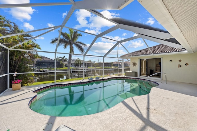 view of swimming pool featuring a lanai, a patio area, and a water view