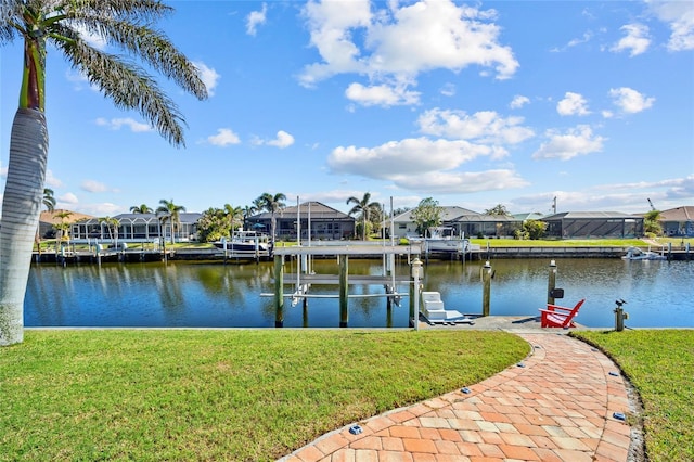 dock area with a water view and a lawn