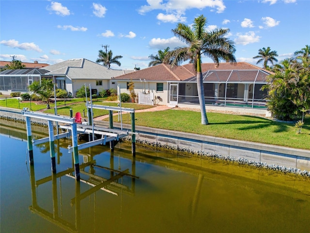 view of dock featuring a water view, a yard, and a lanai