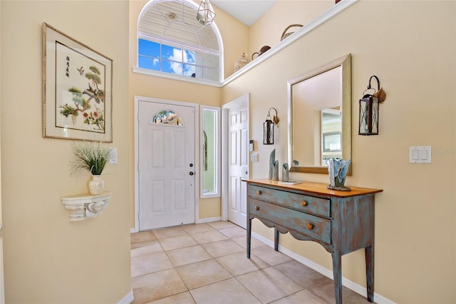 tiled foyer entrance featuring a high ceiling