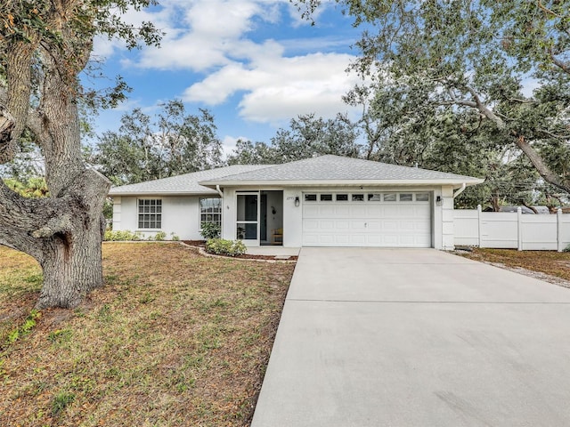 single story home featuring a garage and a front lawn