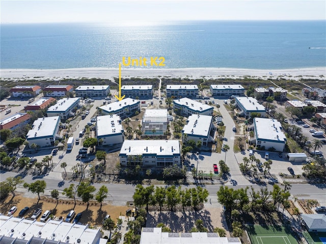 drone / aerial view with a water view and a view of the beach