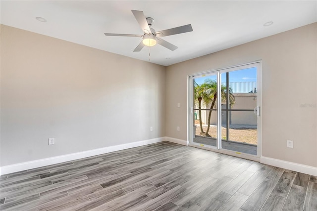 empty room featuring hardwood / wood-style flooring and ceiling fan