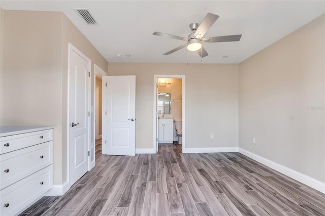 unfurnished bedroom with ceiling fan, ensuite bathroom, and light hardwood / wood-style flooring