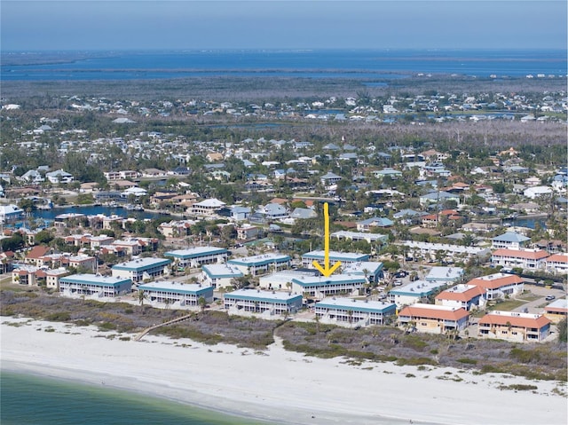 birds eye view of property with a water view and a beach view