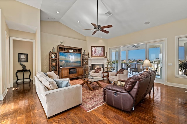 living room featuring lofted ceiling, dark wood-type flooring, and ceiling fan