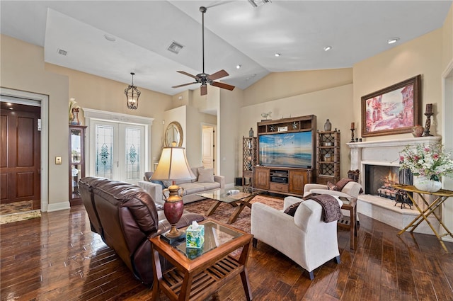 living room with dark hardwood / wood-style flooring, high vaulted ceiling, french doors, and ceiling fan