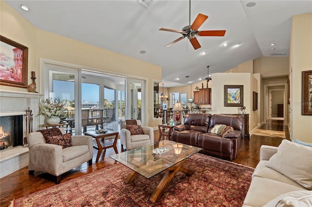 living room featuring ceiling fan, lofted ceiling, and dark hardwood / wood-style flooring