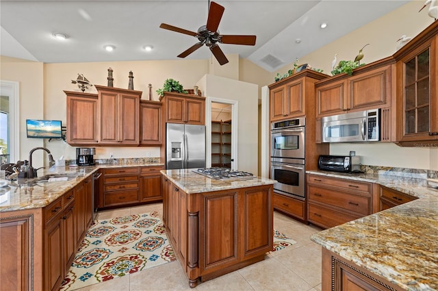 kitchen featuring appliances with stainless steel finishes, sink, light tile patterned floors, kitchen peninsula, and light stone countertops