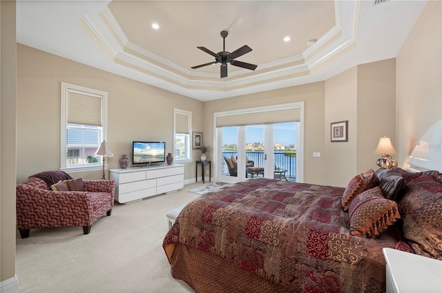 carpeted bedroom featuring access to outside, ornamental molding, a raised ceiling, and ceiling fan