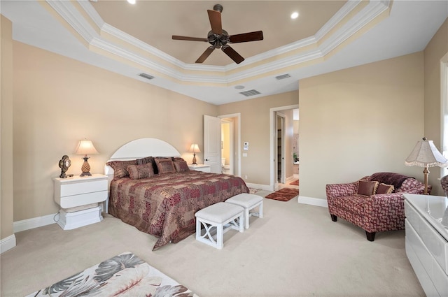 bedroom featuring crown molding, a tray ceiling, light colored carpet, and ceiling fan