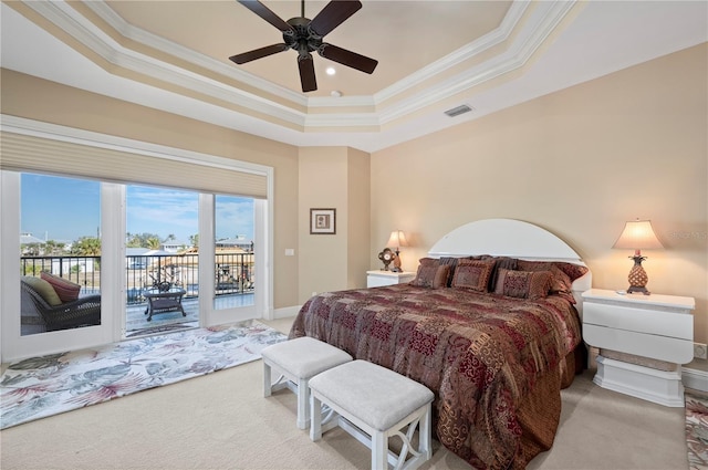 carpeted bedroom featuring crown molding, ceiling fan, a tray ceiling, and access to outside