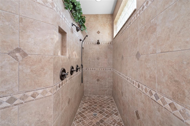 bathroom with a tile shower