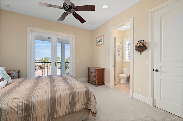 carpeted bedroom with access to outside, ceiling fan, and ensuite bathroom