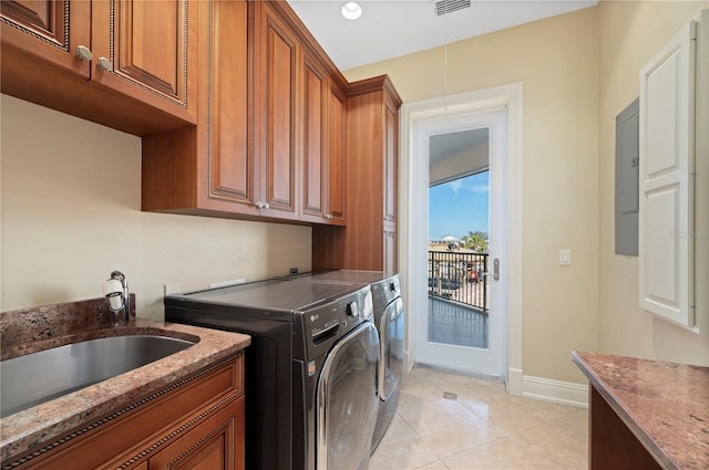 washroom with cabinets, separate washer and dryer, sink, and light tile patterned floors