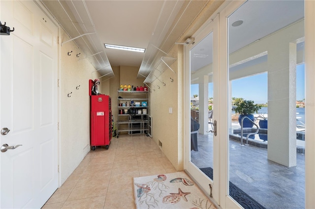 hall featuring light tile patterned floors