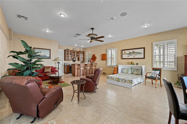 living room with light tile patterned flooring and ceiling fan