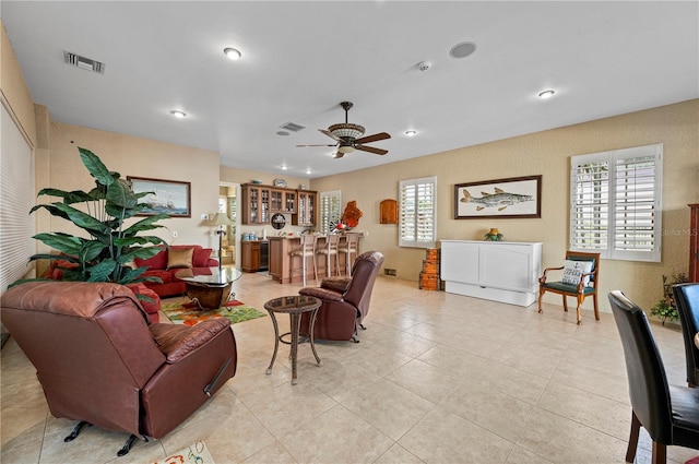 tiled living room featuring ceiling fan