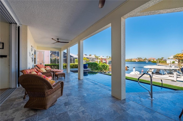 exterior space featuring a water view and ceiling fan