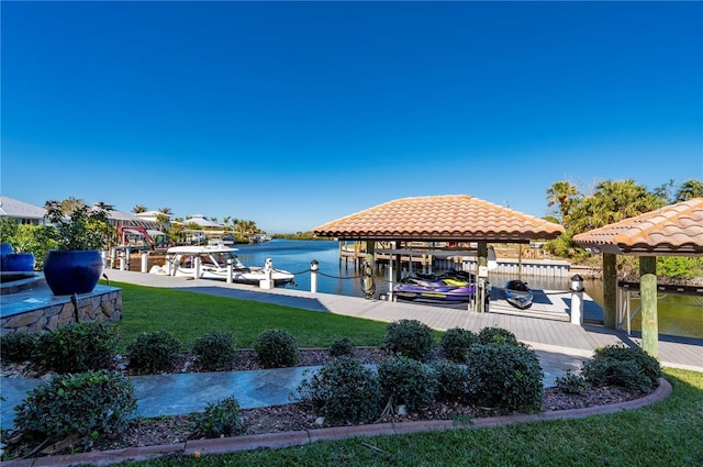 dock area with a yard and a water view