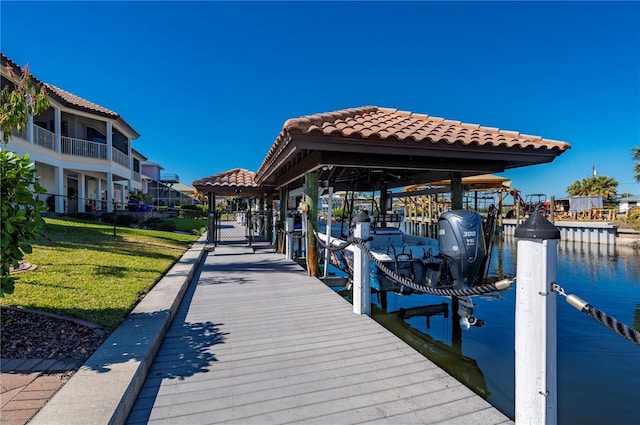 view of dock featuring a lawn and a water view