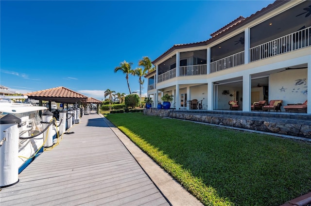 view of dock featuring a lawn