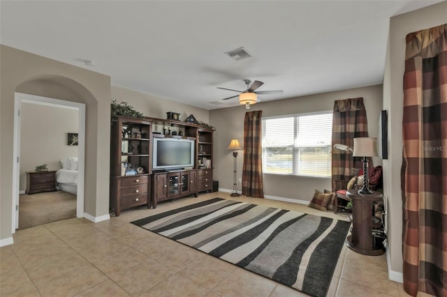 living room with ceiling fan and light tile patterned flooring