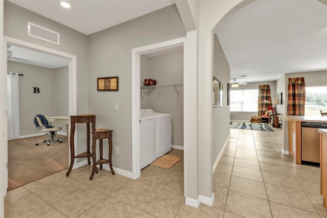 hall with light tile patterned flooring and independent washer and dryer