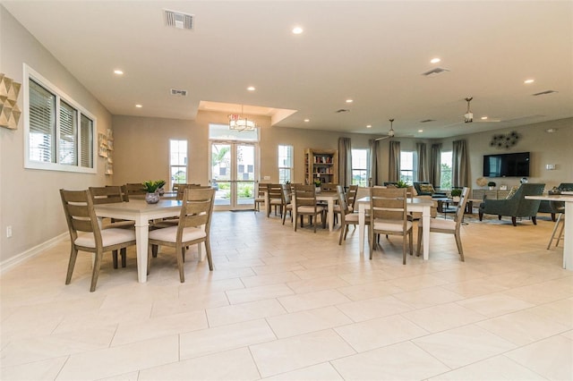 tiled dining area with a wealth of natural light, ceiling fan, and french doors