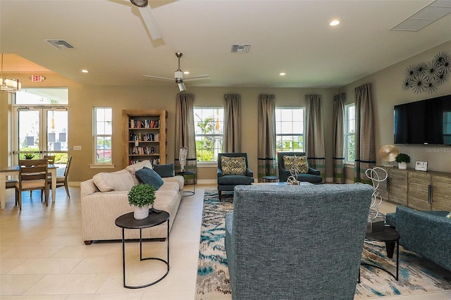 living room featuring light tile patterned flooring, ceiling fan, and french doors