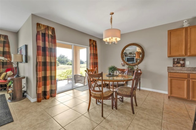 dining area featuring light tile patterned floors and a notable chandelier