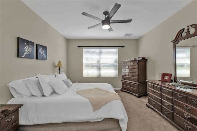 bedroom featuring light carpet and ceiling fan