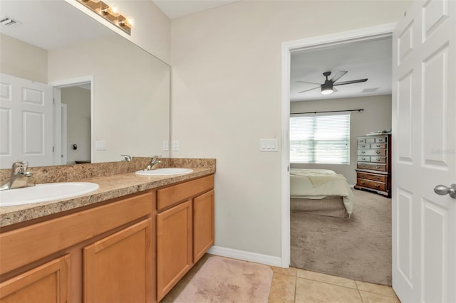 bathroom with tile patterned flooring, vanity, and ceiling fan