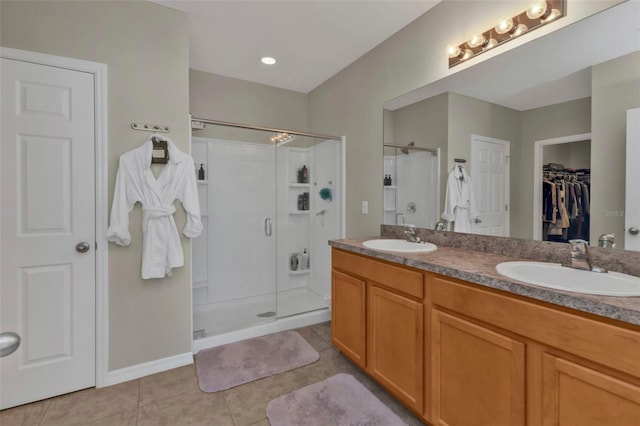 bathroom with tile patterned flooring, vanity, and an enclosed shower