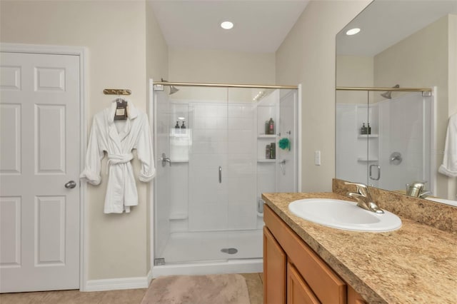 bathroom featuring vanity, tile patterned flooring, and a shower with door